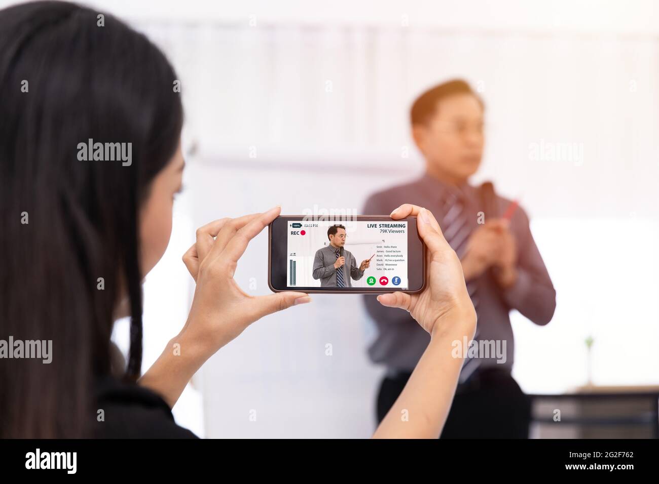Creator people holding smartphone video recording live streaming to online lecture presentation content. Live internet broadcast business meeting teac Stock Photo