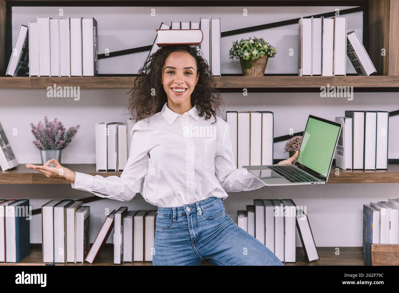 Happy fun university girl teen or business worker doing yoga in the office funny joke relax posture. Stock Photo