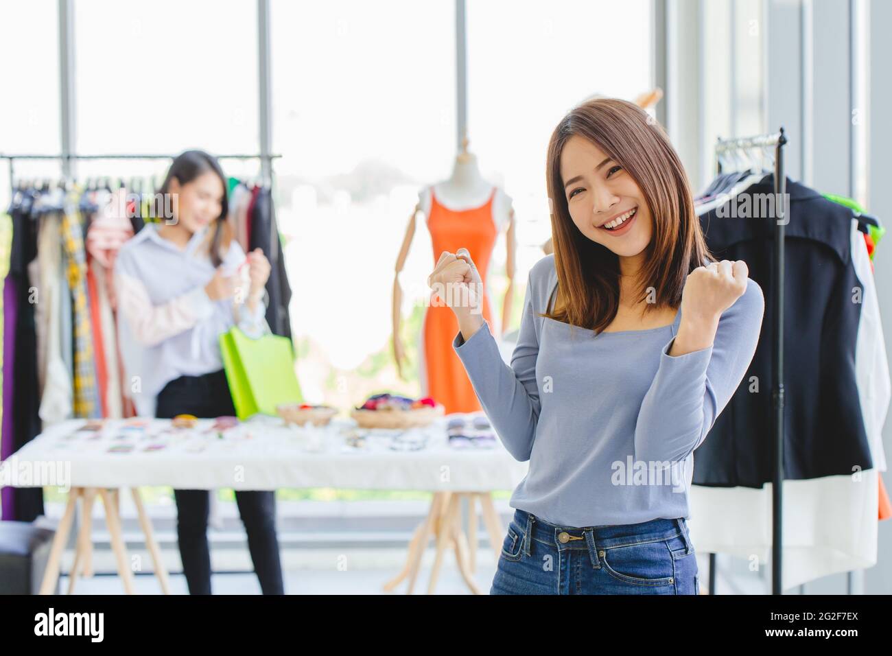 Young Asian girl teen SME clothing shop owner happy smile gladful with opening new business promotion and customer. Stock Photo
