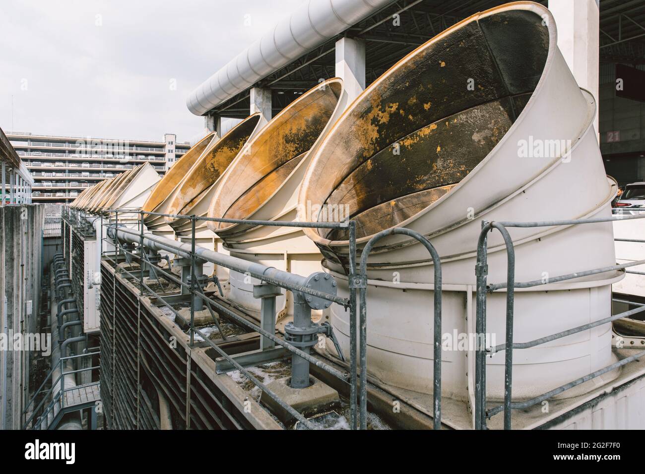 Closeup Air cooling tower for HVAC chilling tower pipe ventilator air hole units at building rooftop outdoor blue sky. Stock Photo