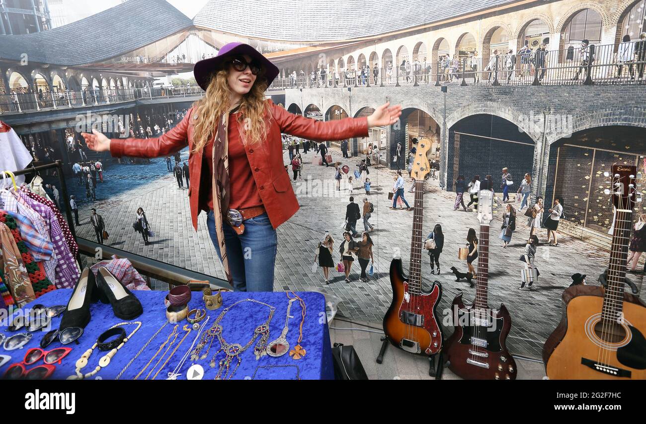 A girl in 70's vintage style clothes poses at classic car boot sale Stock Photo