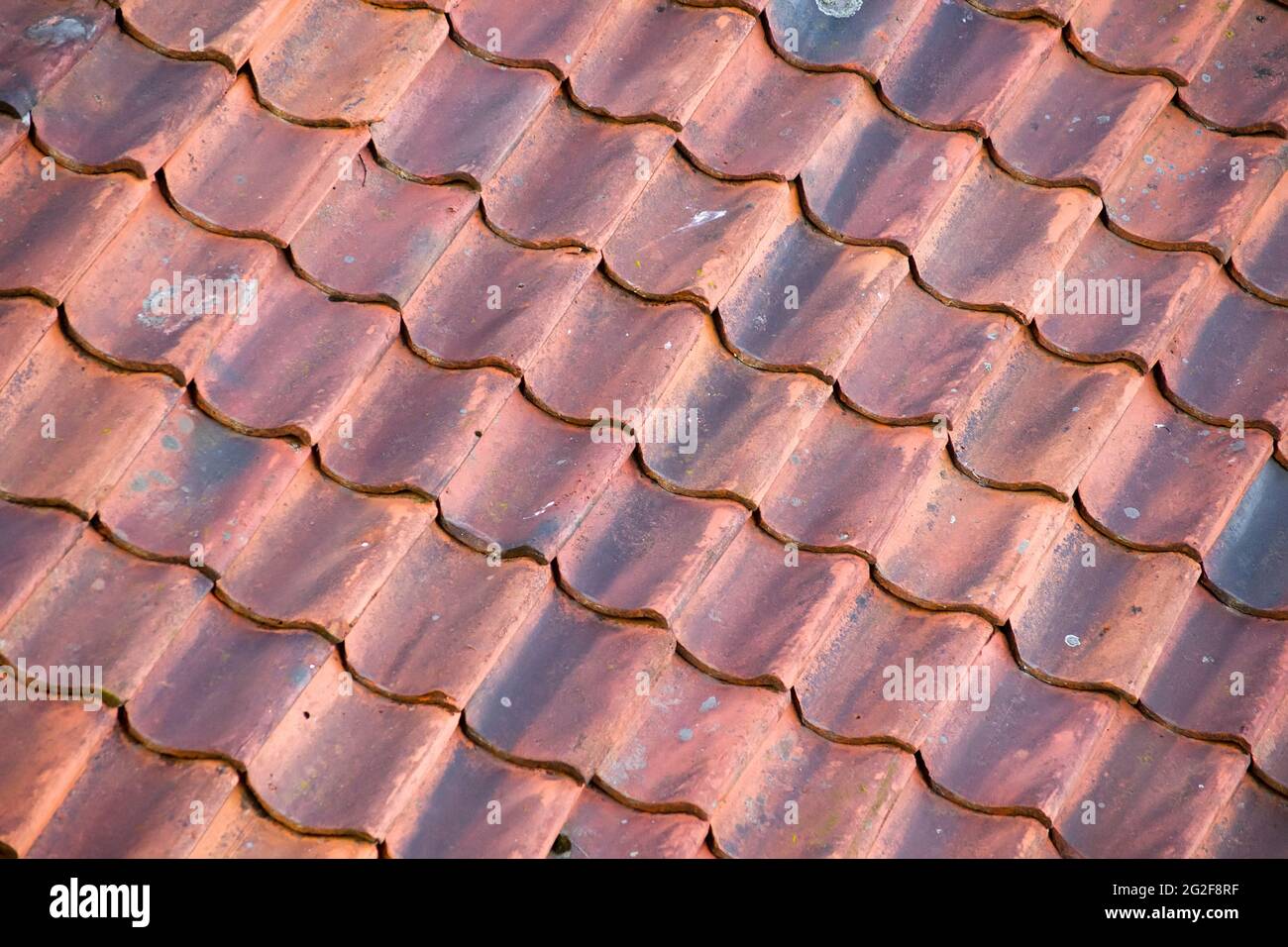 Background of red roof made of old tiles. In diagonal composition. Stock Photo