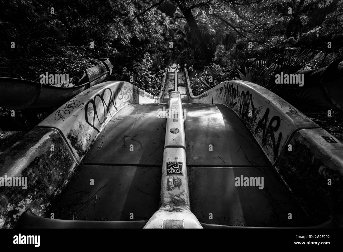 Abandoned water park Thuy Tien Lake in Hue, Vietnam. Beautiful landscape of jungle overcoming architecture. Stock Photo