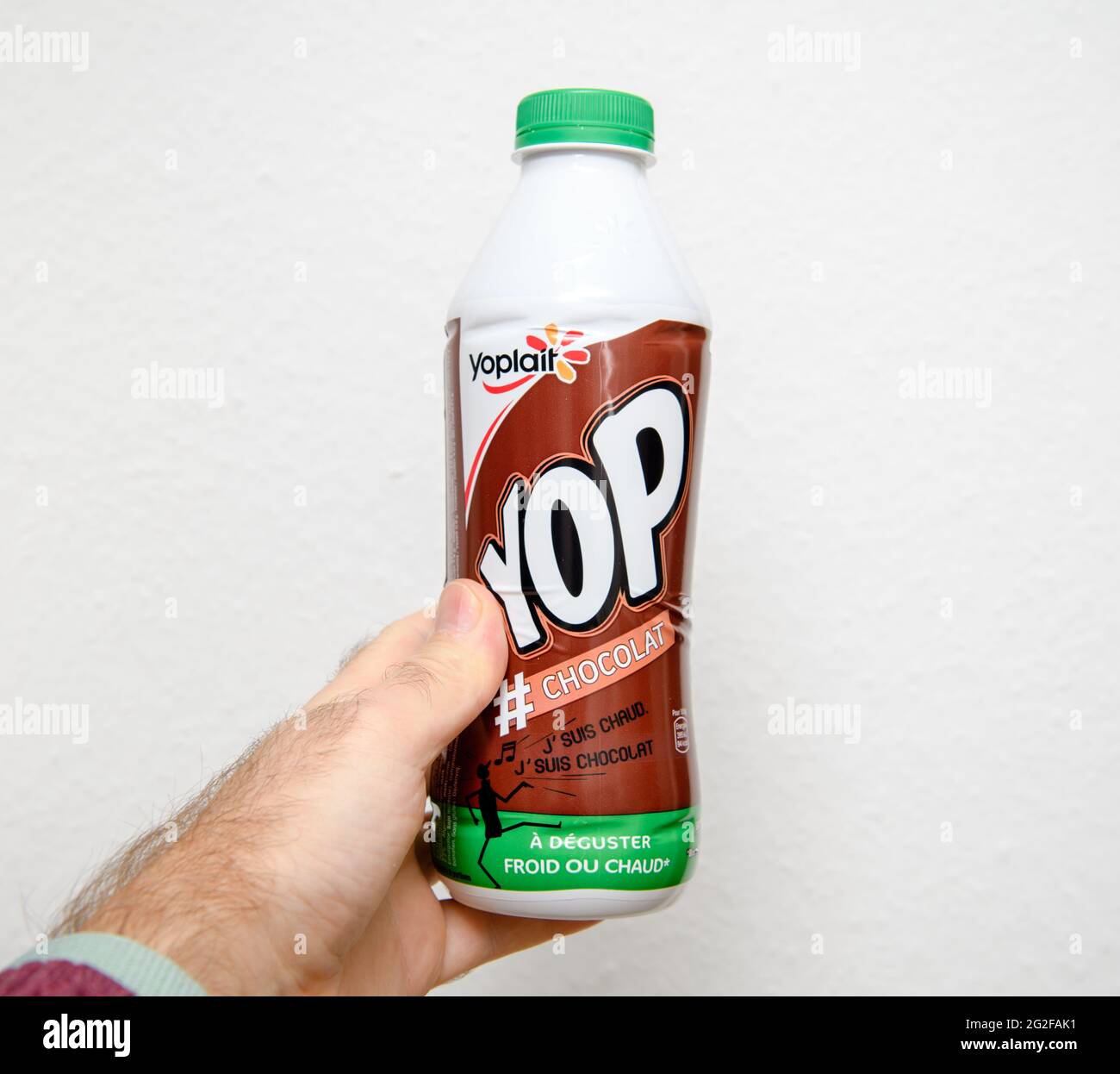 POV male hand holding looking at the bottle of Yoplait Yop Stock Photo