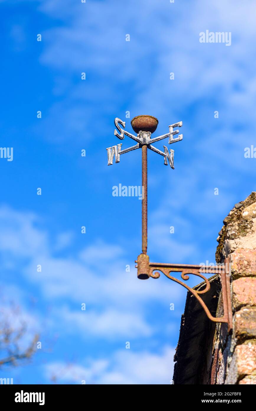 Old weathervane on the side of a barn, missing the cockrel. Stock Photo