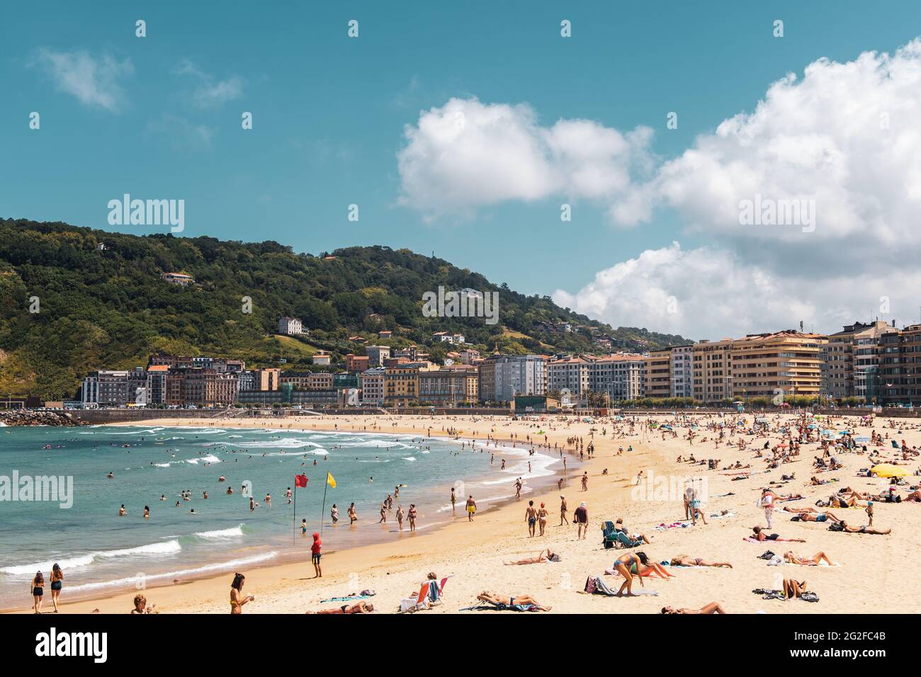 Crowded Zurriola Beach Donostia San Sebastian, Basque Country, Spain - Panorama Stock Photo