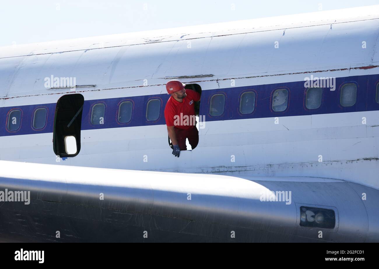 11 June 2021 Hamburg An Employee Of A Dismantling Company Looks Out Of A Removed Emergency Door Of A Boeing 707 430 One Of Lufthansa S Oldest Jet Aircraft Has Been Being Dismantled In