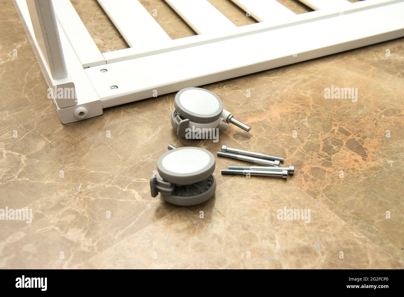 Selective focus shot of parts for assembling a baby crib wheels and