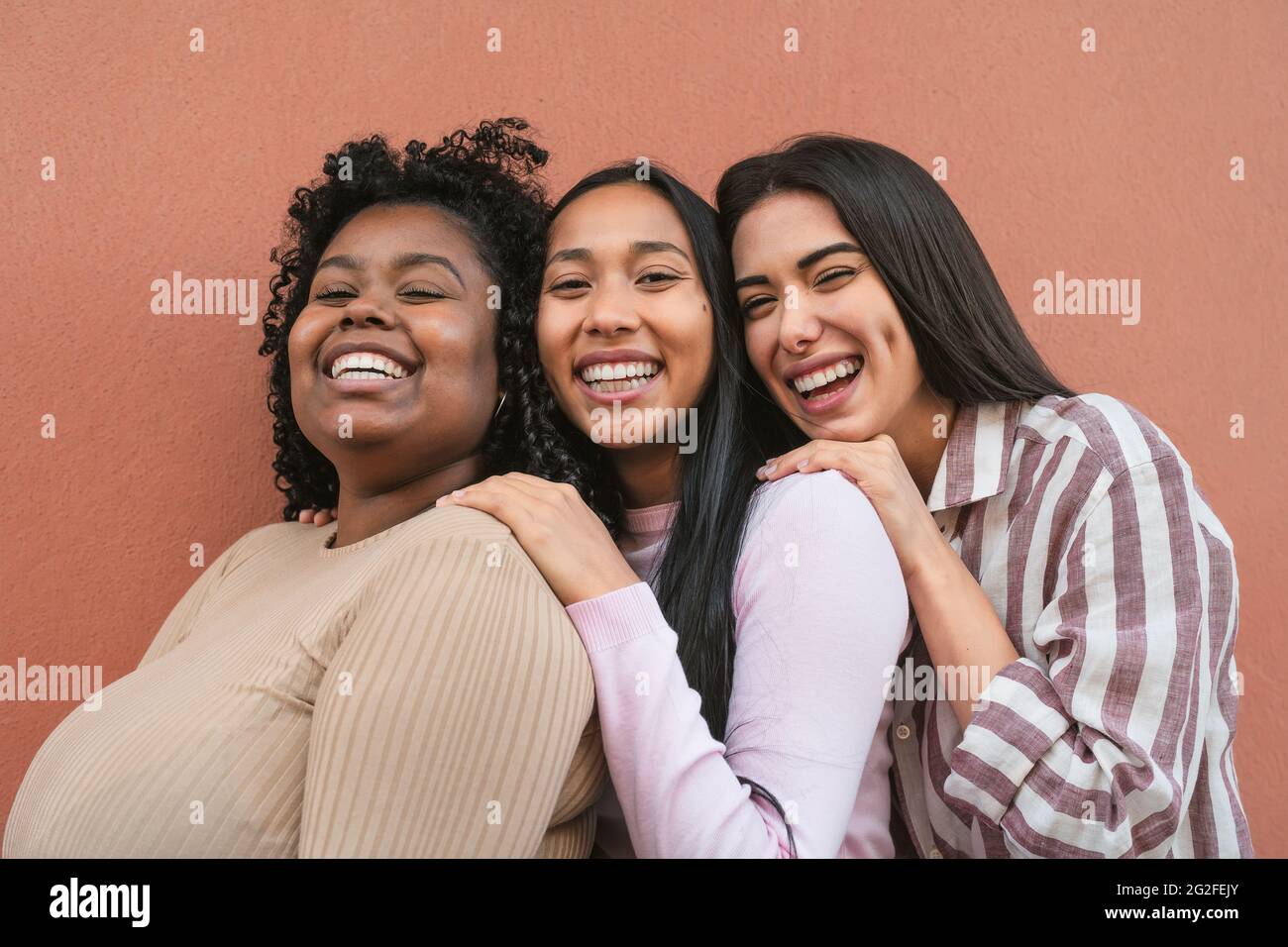Happy multiracial friends having fun smiling together in front of ...