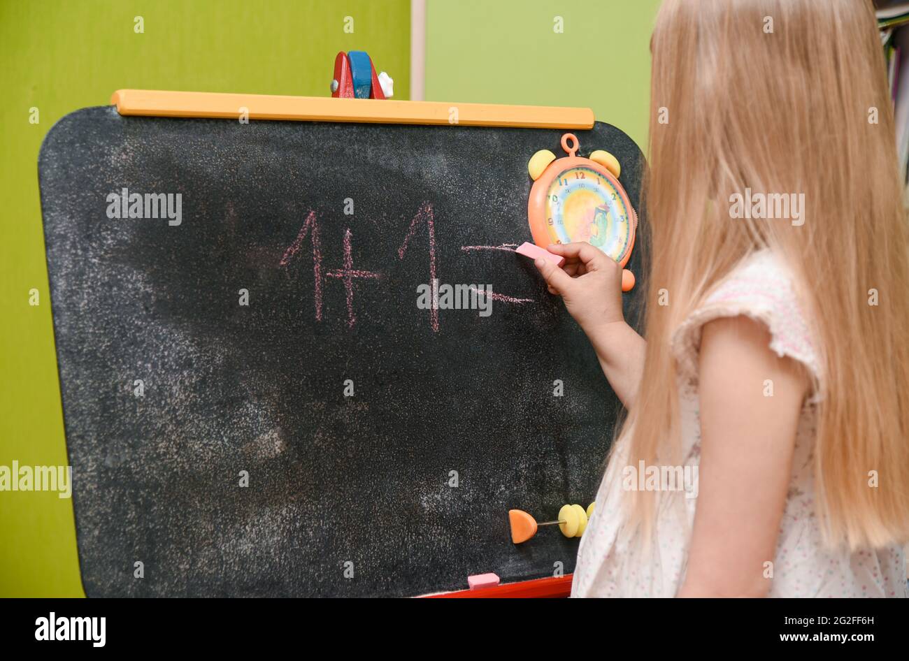 Child girl learning to write on drawing board at home Stock Photo Alamy
