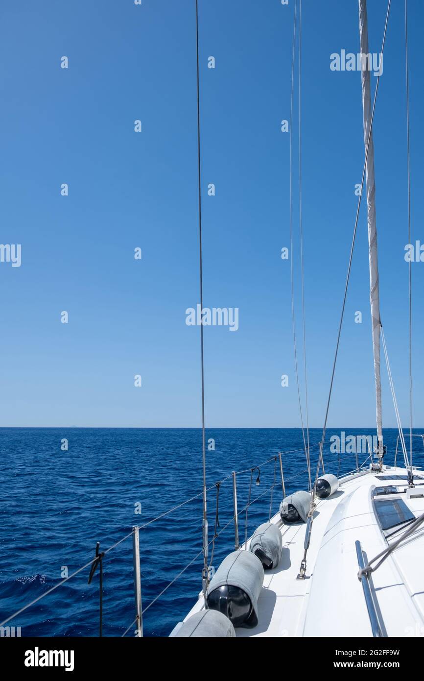 Yacht cruising in Aegean sea. White sloop rigged sailboat sailing in ...