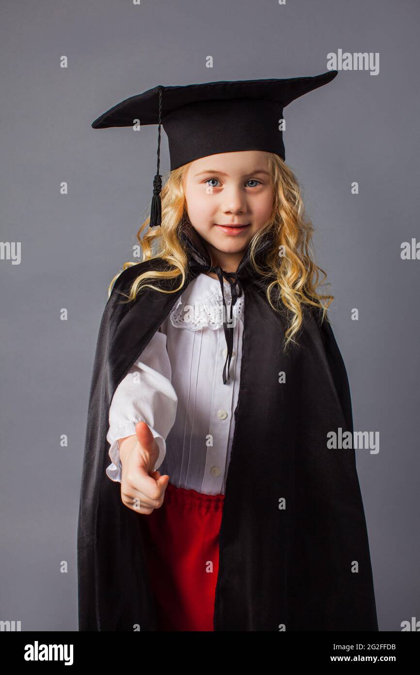 The little girl in a judge's costume shows a thumb up Stock Photo Alamy