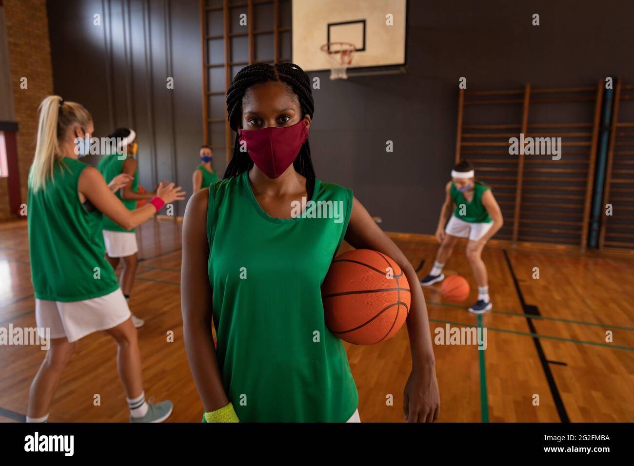 Portrait of african american female basketball player wearing face mask
