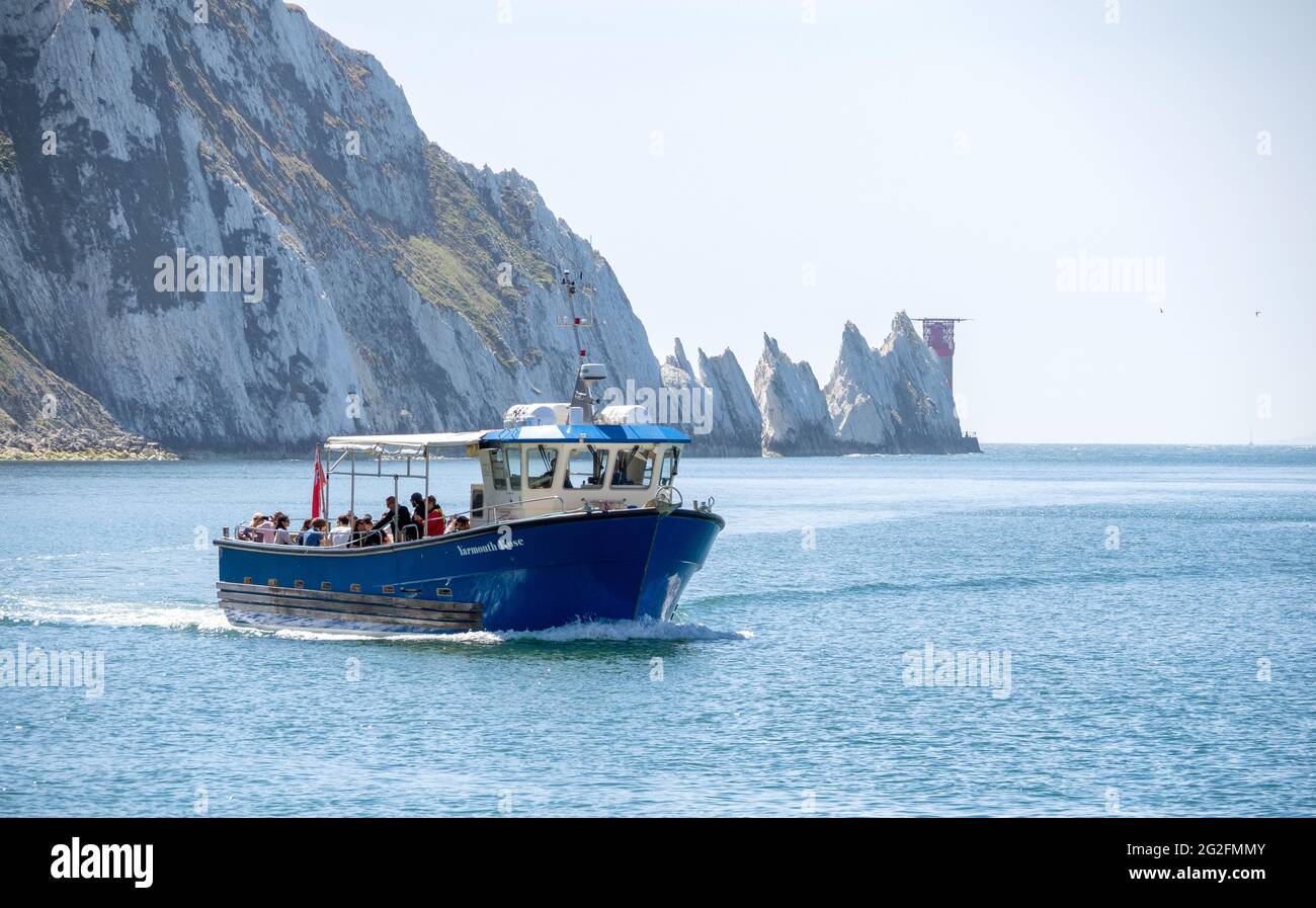 Tourist boat trip returning from The Needles chalk stacks lighthouse to Alum Bay at the western point of the Isle of Wight UK Stock Photo