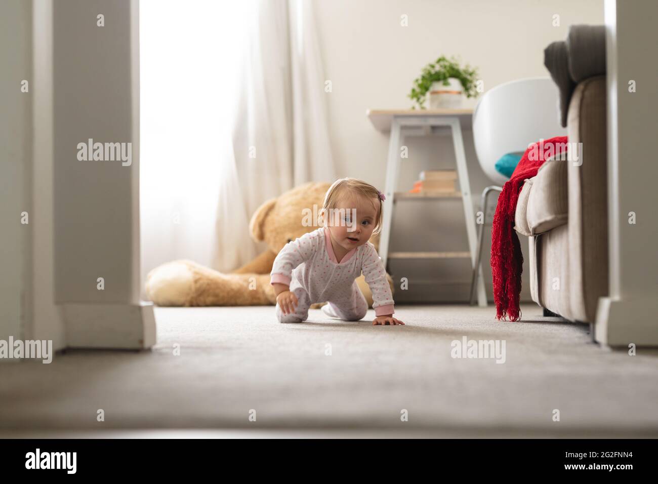 Caucasian cute baby crawling on the floor at home Stock Photo