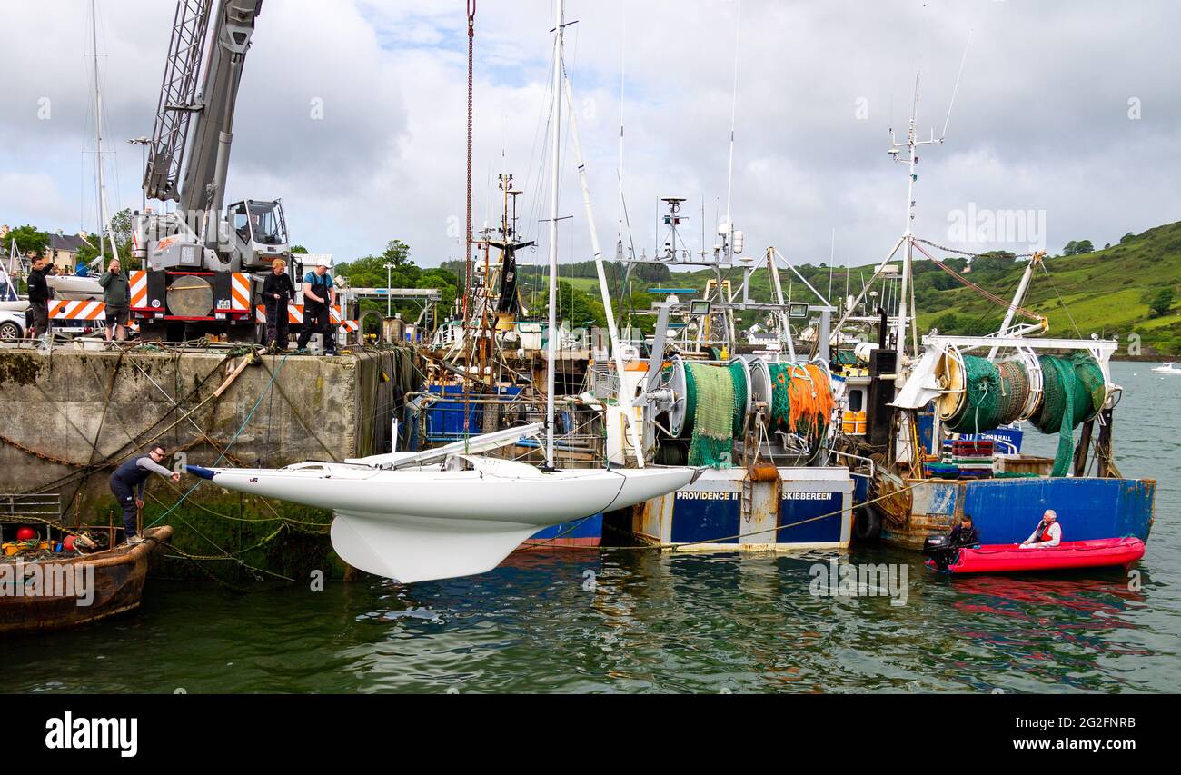 Dragon Class racing yacht being craned into the water, Keelbeg,Union Hall, West Cork, Ireland Stock Photo