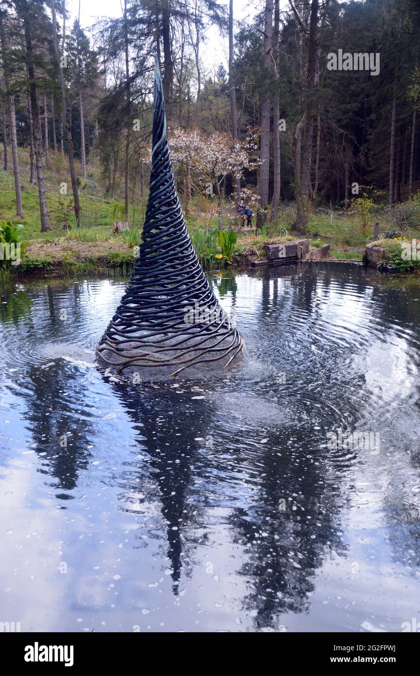 The Metal Pinnacle Water Fountain Sculpture in a Pond at The Himalayan Garden & Sculpture Park, Grewelthorpe, Ripon, North Yorkshire, England, UK. Stock Photo