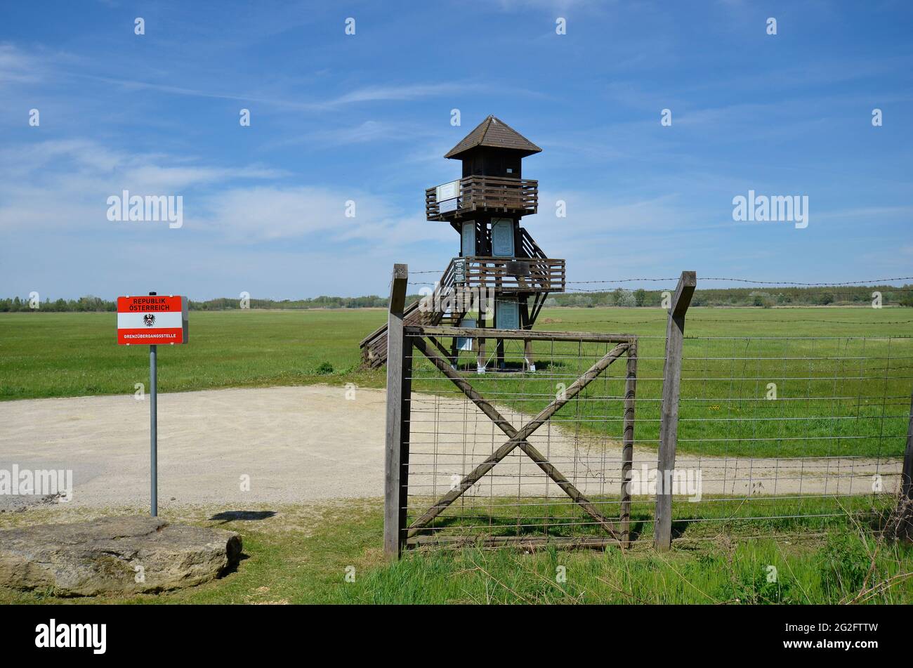 Andau, Austria - May 04, 2021: Lookout tower at the border crossing point with remains of the barbed wire fence  named - Iron Curtain - along the Aust Stock Photo