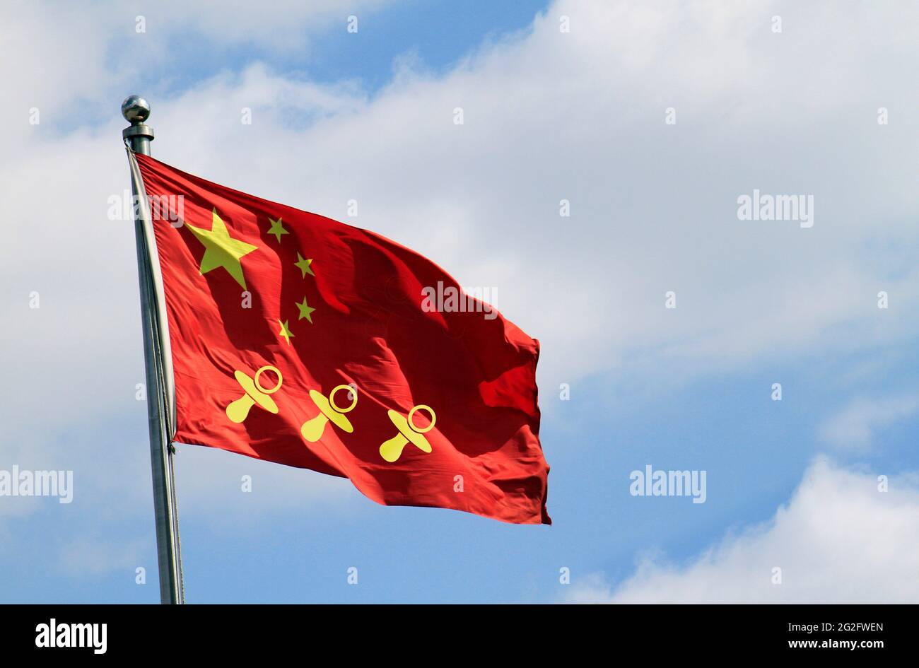 Three pacifier icons on a Chinese national flag - China allows three children in major policy shift announced in May 2021 Stock Photo