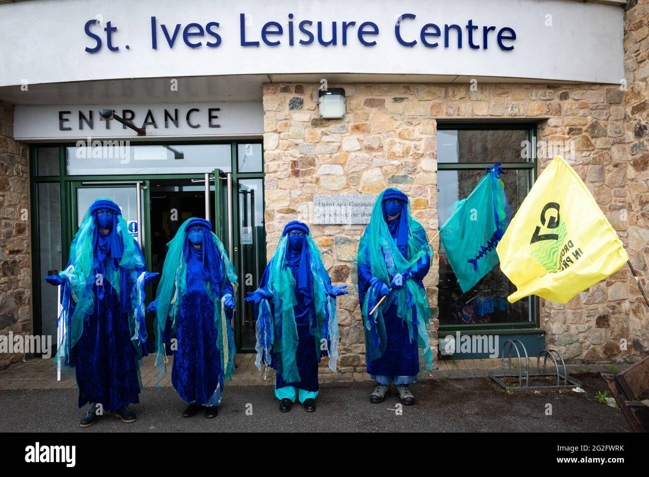 St Ives, UK. 11th June, 2021. The Extinction Rebellion await the start of an anti-G7 march to begin in St Ives. Extinction Rebellion organised the demonstration to coincide with the G7-Summit. The event sees world leaders come together to discuss matters around climate change. Credit: Andy Barton/Alamy Live News Stock Photo