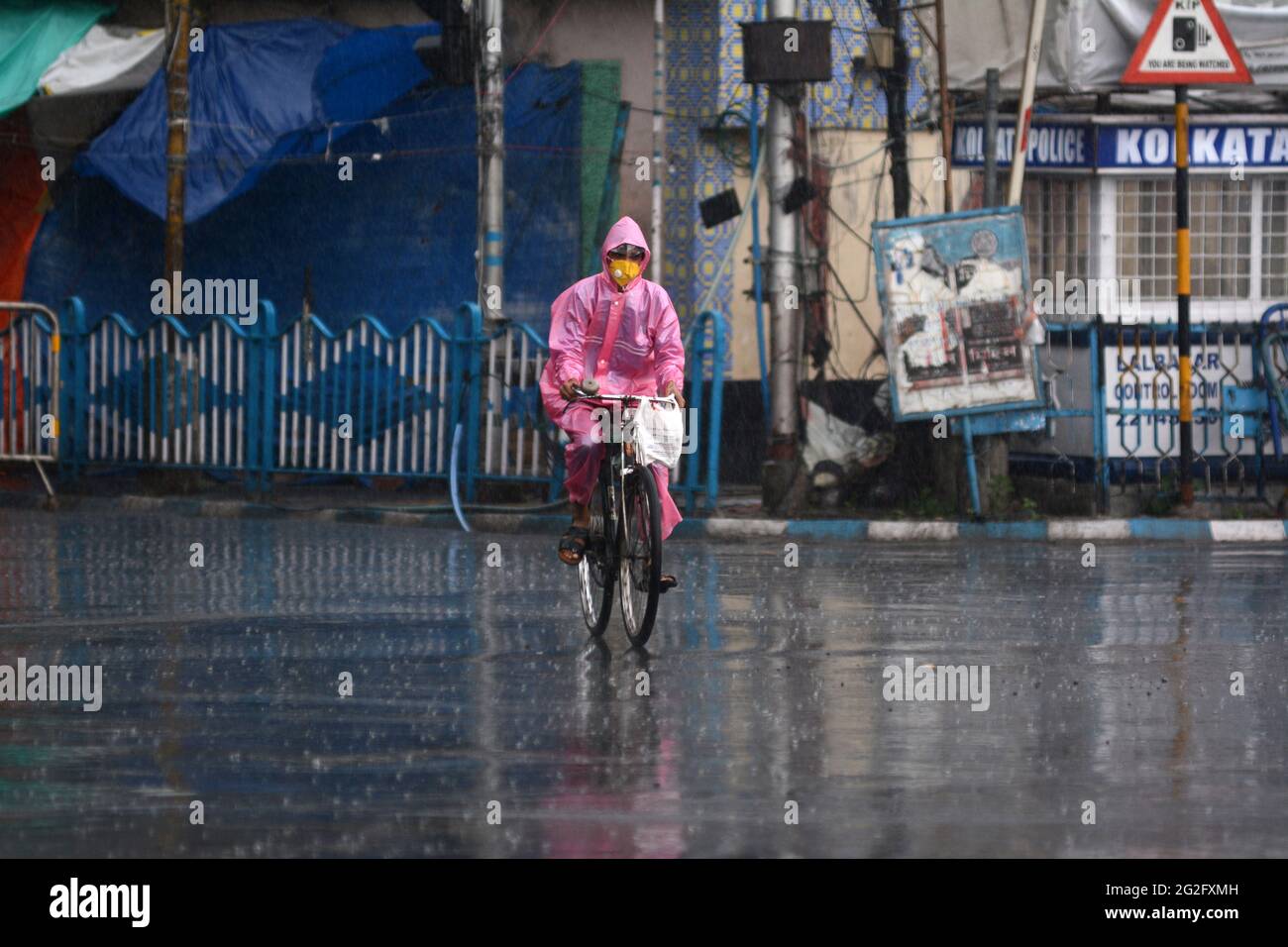 Kolkata, West Bengal, India. 11th June, 2021. A man rides a bicycle as the heavy rainfall lashes Kolkata, India. Credit: Indranil Aditya/ZUMA Wire/Alamy Live News Stock Photo