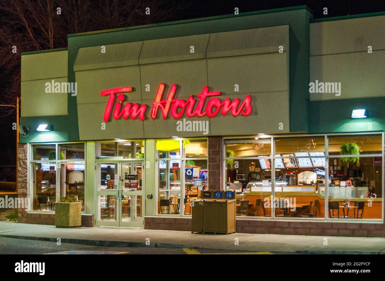 Tim Horton's restaurant during a Winter night with snow. Tim Hortons Inc is a Canadian multinational fast-casual restaurant known for its coffee and d Stock Photo