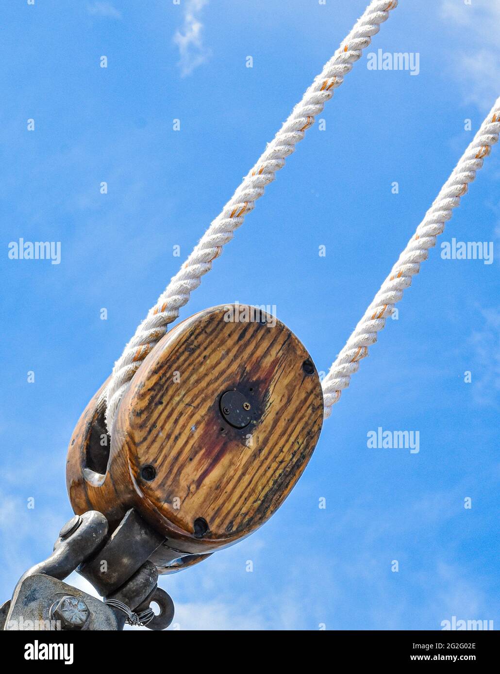 An antique wooden block and tackle on a historic sailing ship. Copy space. Stock Photo