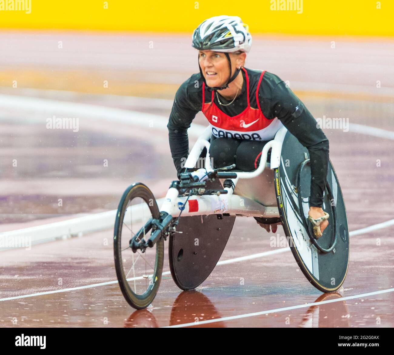 Canadian wheelchair racing athlete racing on a wet track at the 2015 Parapan American Games. The 2015 Parapan American Games commonly known as the Tor Stock Photo
