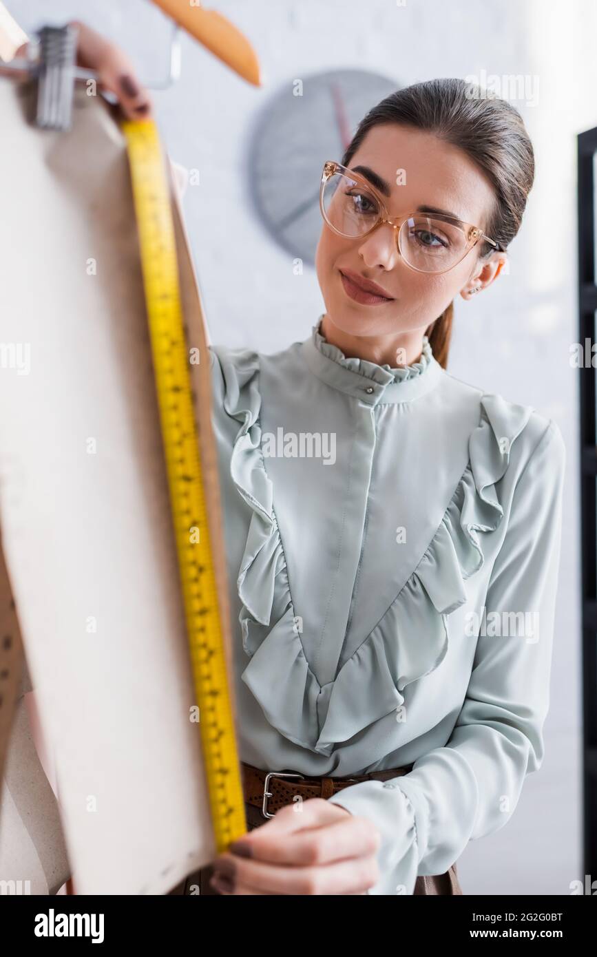 Beautiful And Young Seamstress With A Measuring Tape On Her Neck Stock  Photo, Picture and Royalty Free Image. Image 141299431.