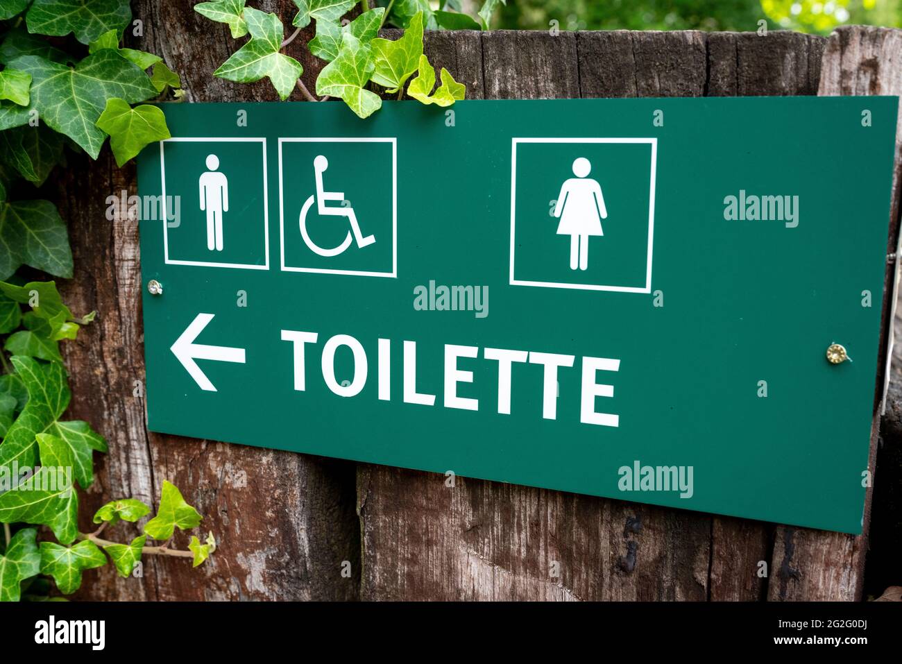 Green direction sign toilette, men ,women and disabled. Stock Photo