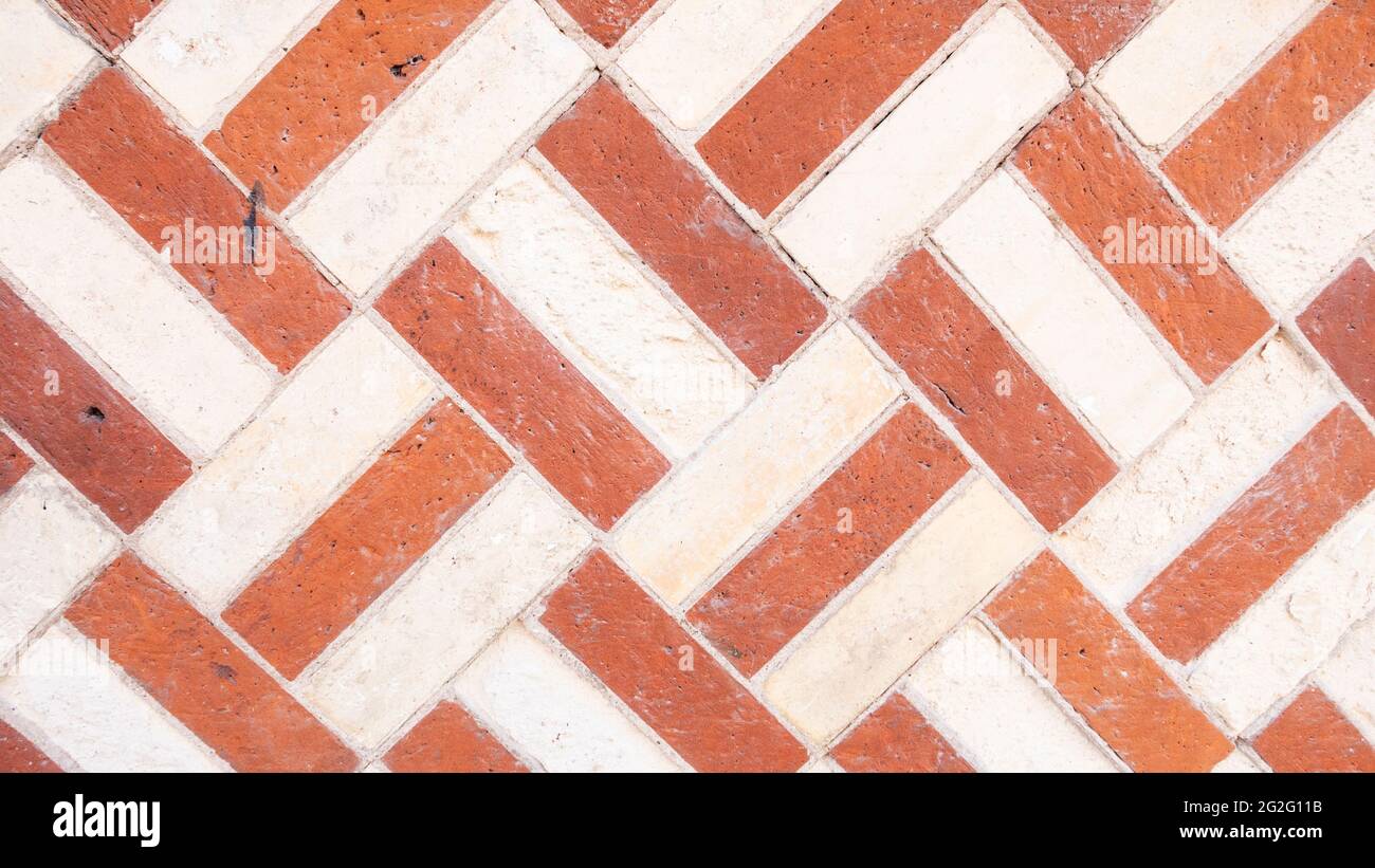 Herringbone chevron pattern Brick wall background variety of bricks brick wall made with regular new house bricks High resolution high quality photo Stock Photo