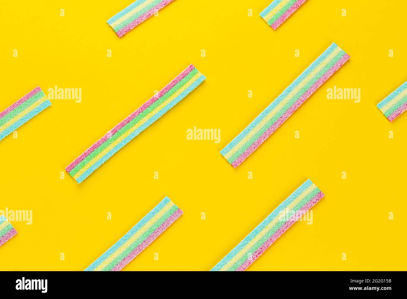 Licorice Candy. Sweet gummy sticks with different flavor, on yellow