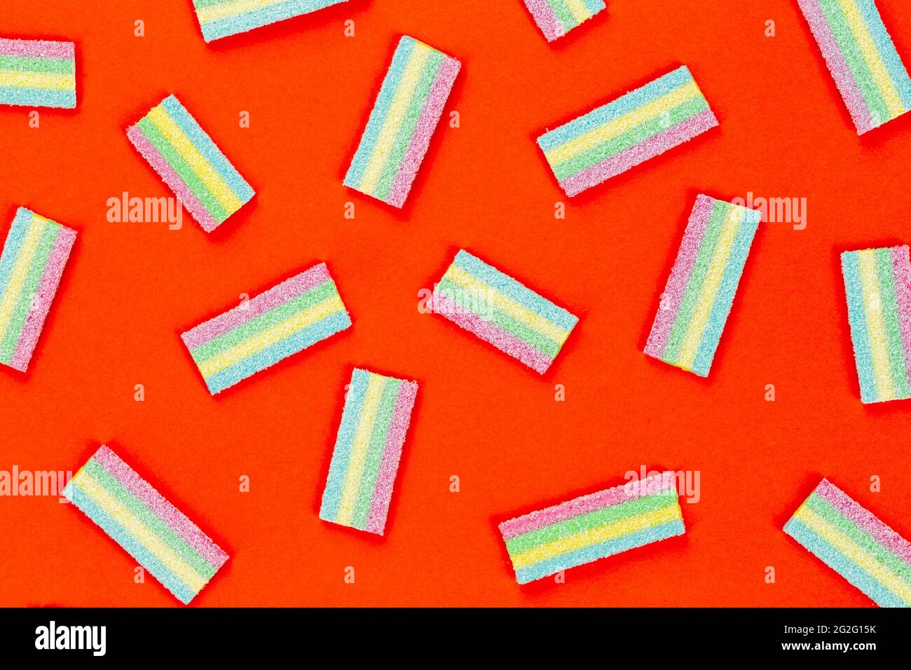 Licorice Candy. Sweet gummy sticks with different flavor, on red