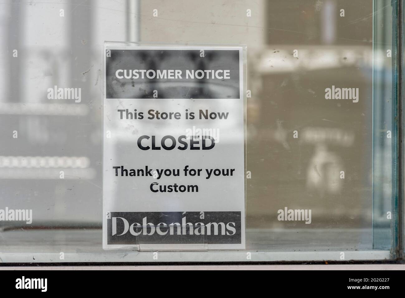 Closed sign in the window display of Debenhams in High Street, Southend on Sea, Essex, UK. Customer notice. This store is now closed, thank you custom Stock Photo