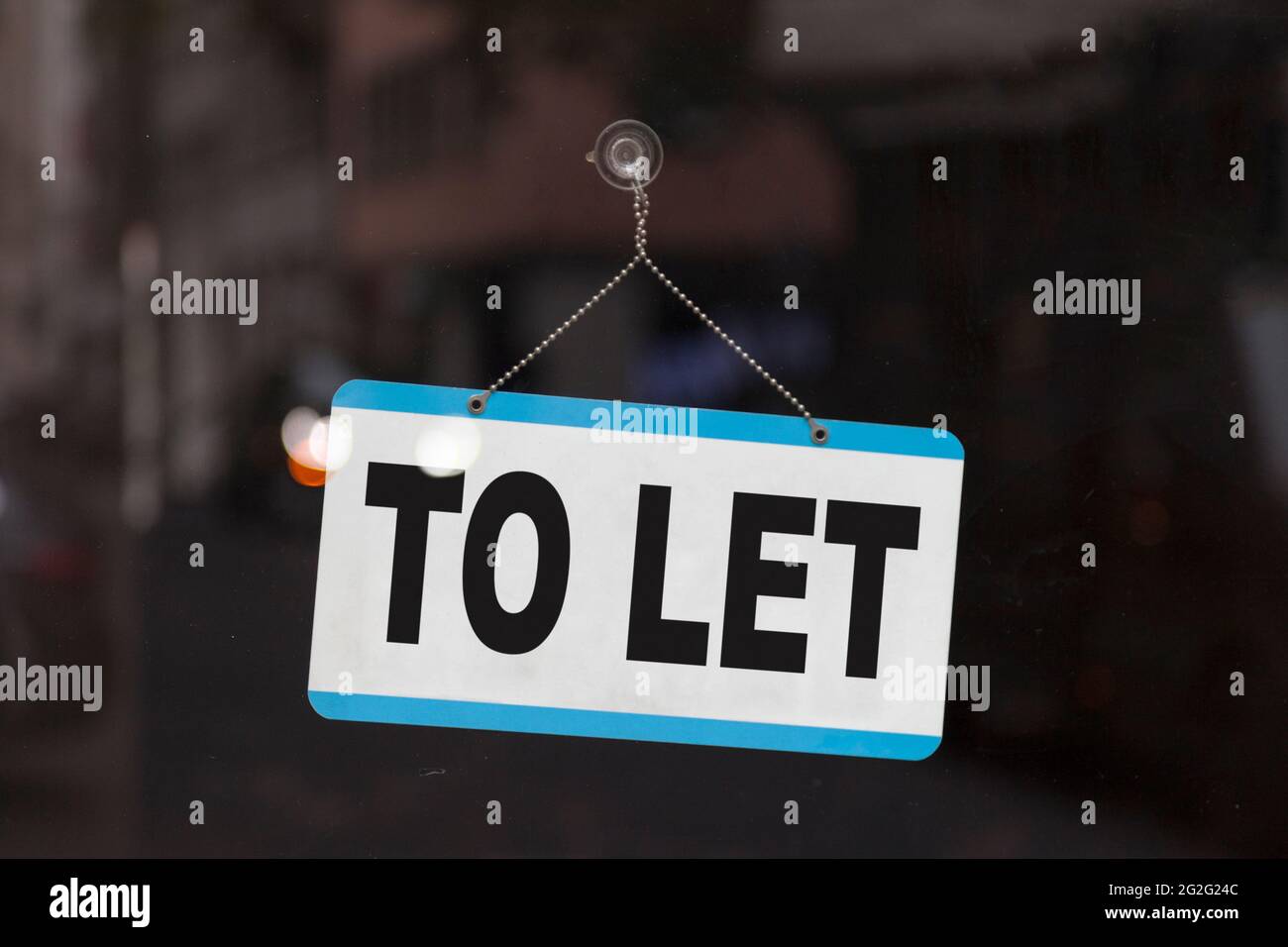 Close-up on a sign in the window of a shop displaying the message: To let. Stock Photo