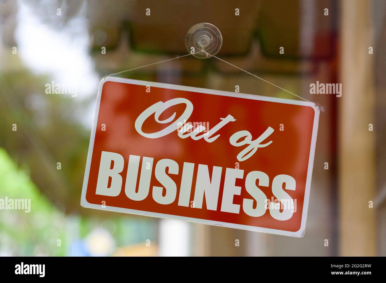 Close-up on a red sign in the window of a shop displaying the message: Out of business. Stock Photo