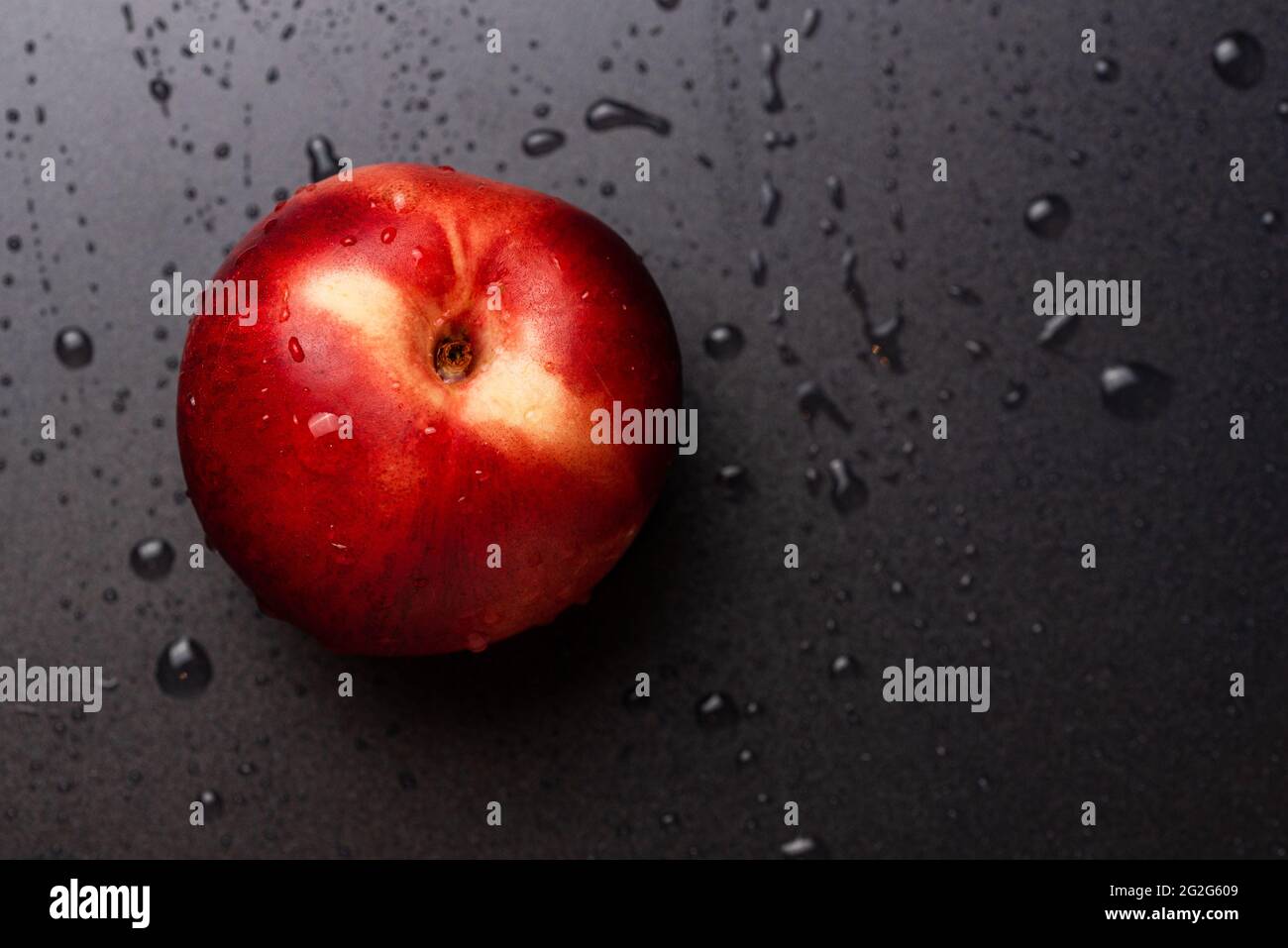 Nectarine fruit isolated on wet black background Stock Photo