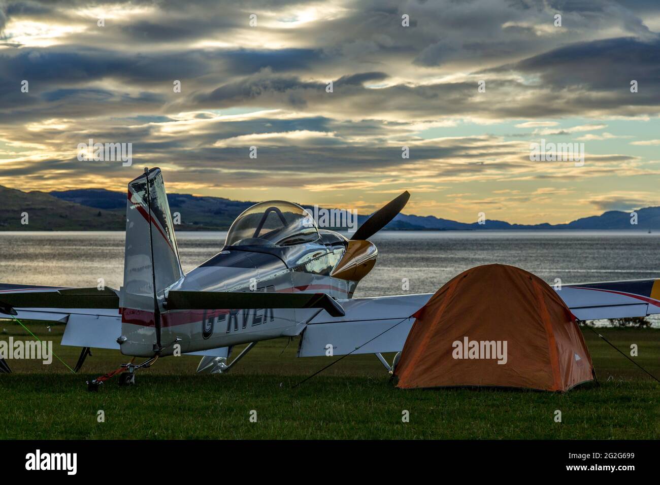 A Van's RV-4 aircraft, G-RVER, at Glenforsa Airfield, Isle of Mull, Scotland. Pilot has pitched a tent beside the aircraft. Stock Photo