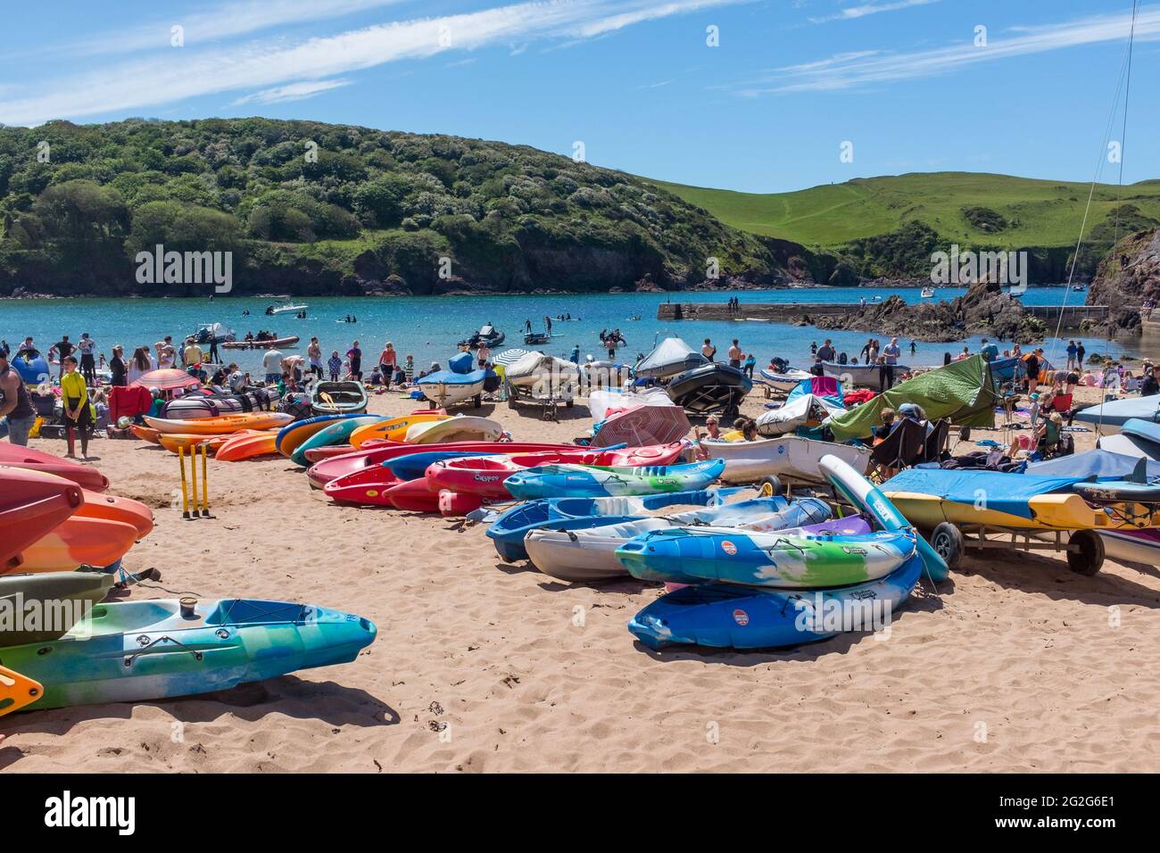 Holiday makers and boats on the beach at the holiday village of Hope Cove in the South Hams, Devon near Kingsbridge Stock Photo