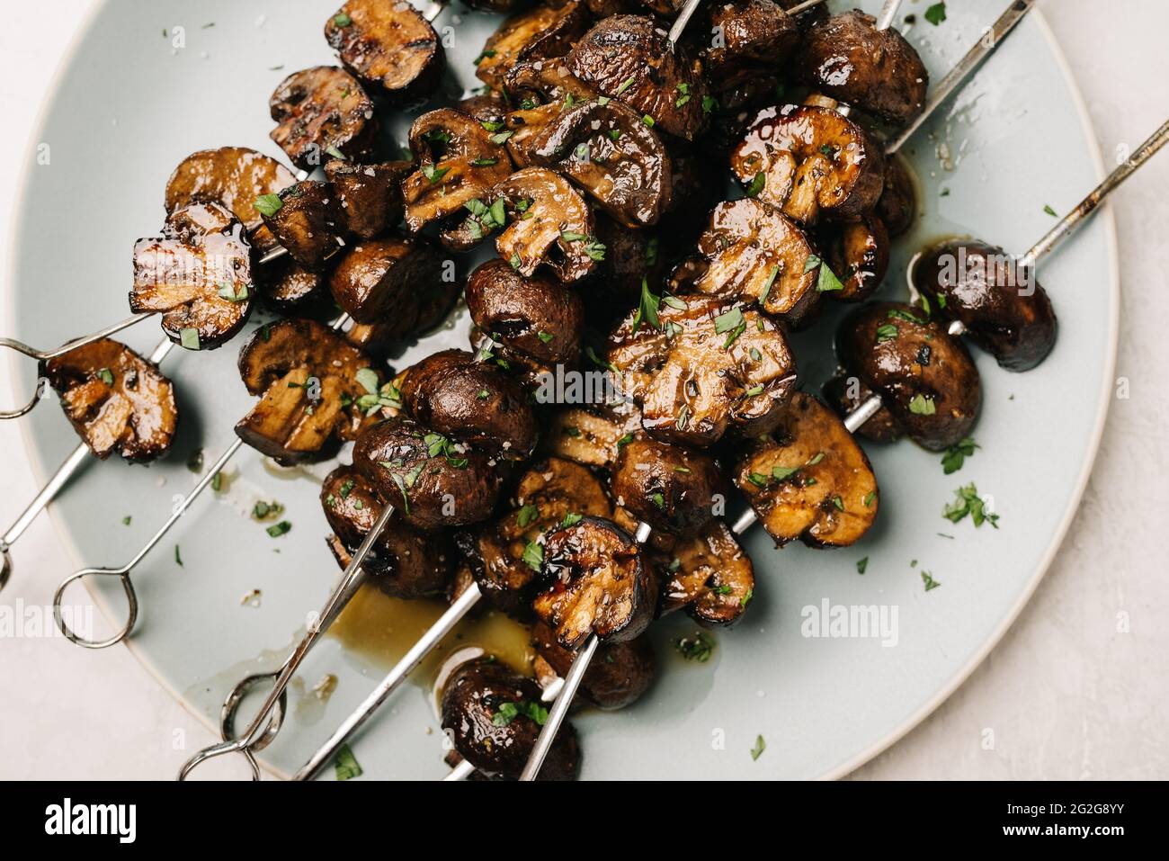 Overhead photo of grilled marinated Cremini mushroom skewers Stock