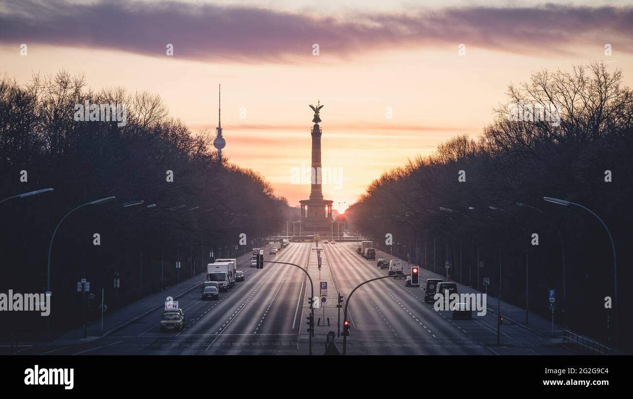 Dawn behind the Strasse des 17. Juni with the Victory Column and TV Tower in Berlin. Stock Photo