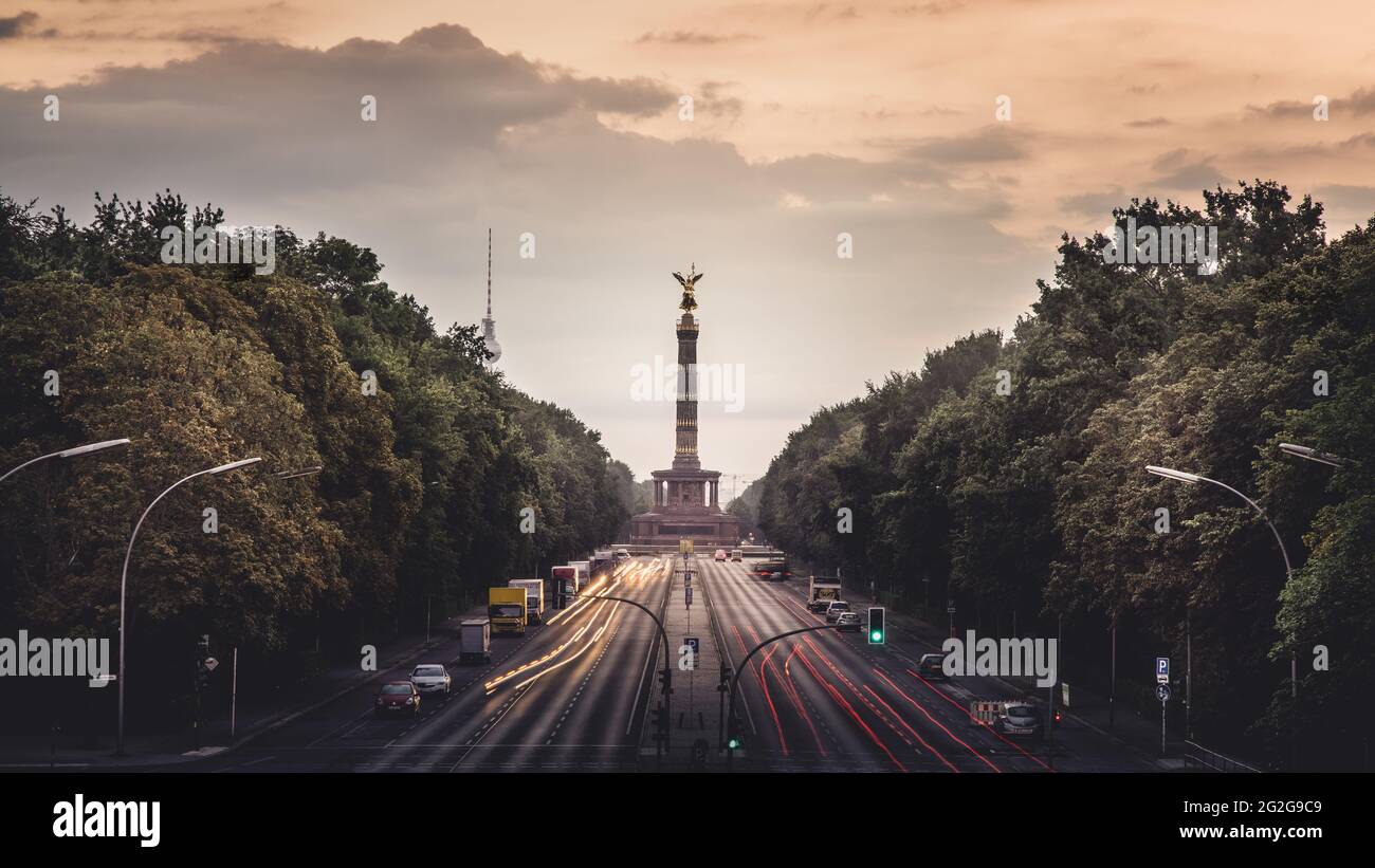 Dawn behind the Strasse des 17. Juni with the Victory Column and TV Tower in Berlin. Stock Photo