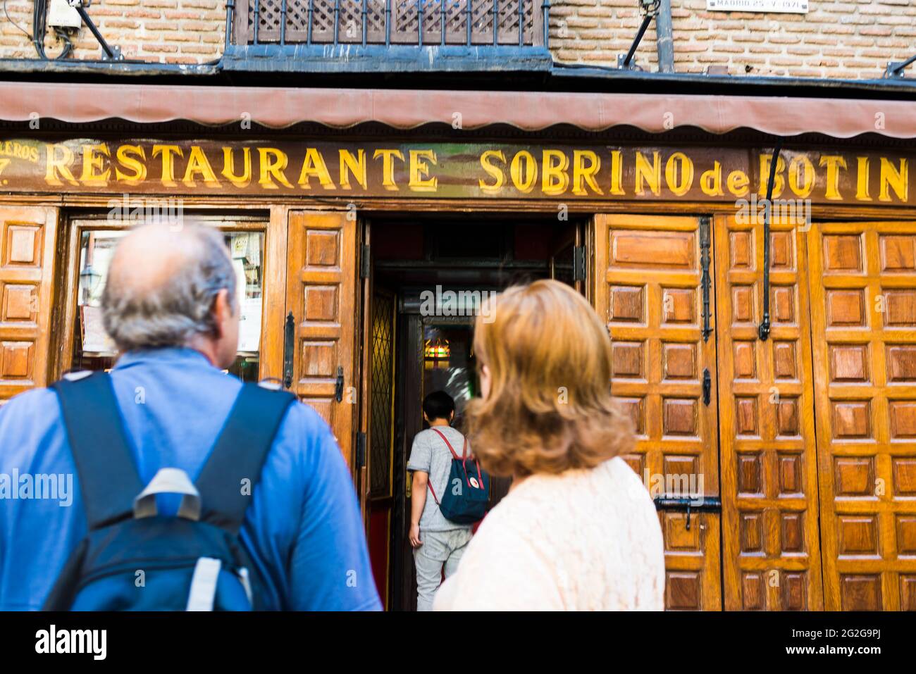 Group of tourists in front of Sobrino de Botín, a Spanish restaurant in Madrid, founded in 1725, that is the oldest restaurant in the world in continu Stock Photo