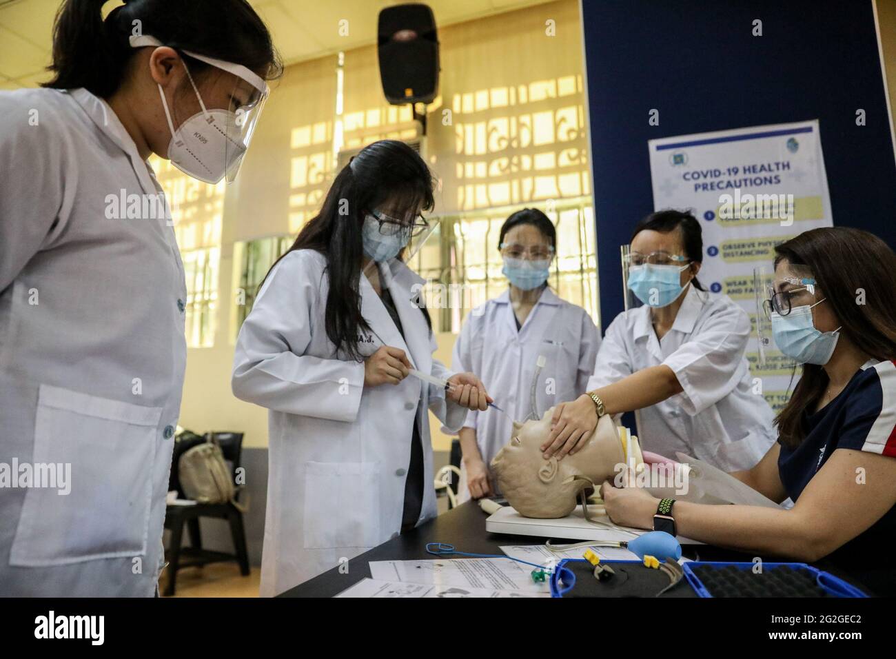 Manila, Philippines. June 10th 2021. Medical students perform an endotracheal intubation on a dummy during a face-to-face class at the University of Santo Tomas. The university started its limited face-to-face classes after the government allowed the resumption hands-on training and laboratory classes in campuses while observing health protocols to prevent the spread of the coronavirus disease. Stock Photo