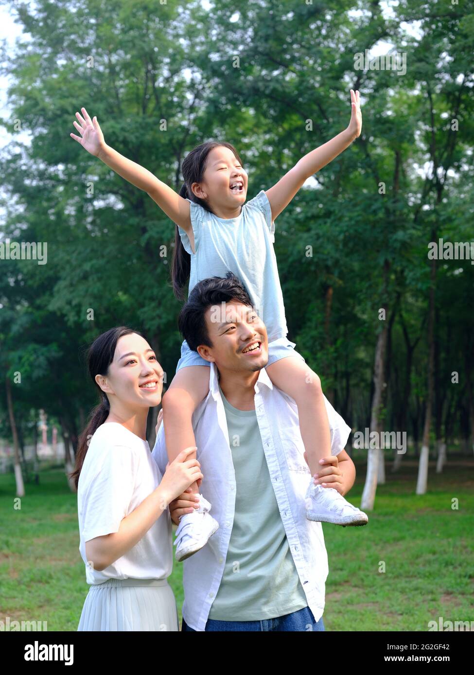 Happy family of three playing in the park high quality photo Stock ...