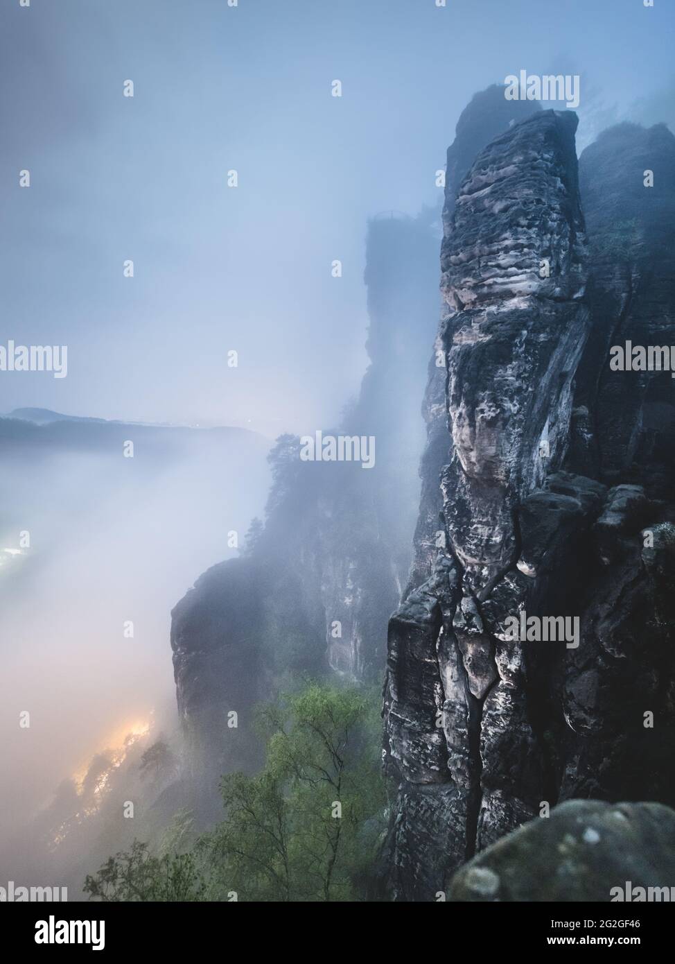 Nocturnal view from the Bastei bridge in the misty Elbe Sandstone Mountains. Stock Photo