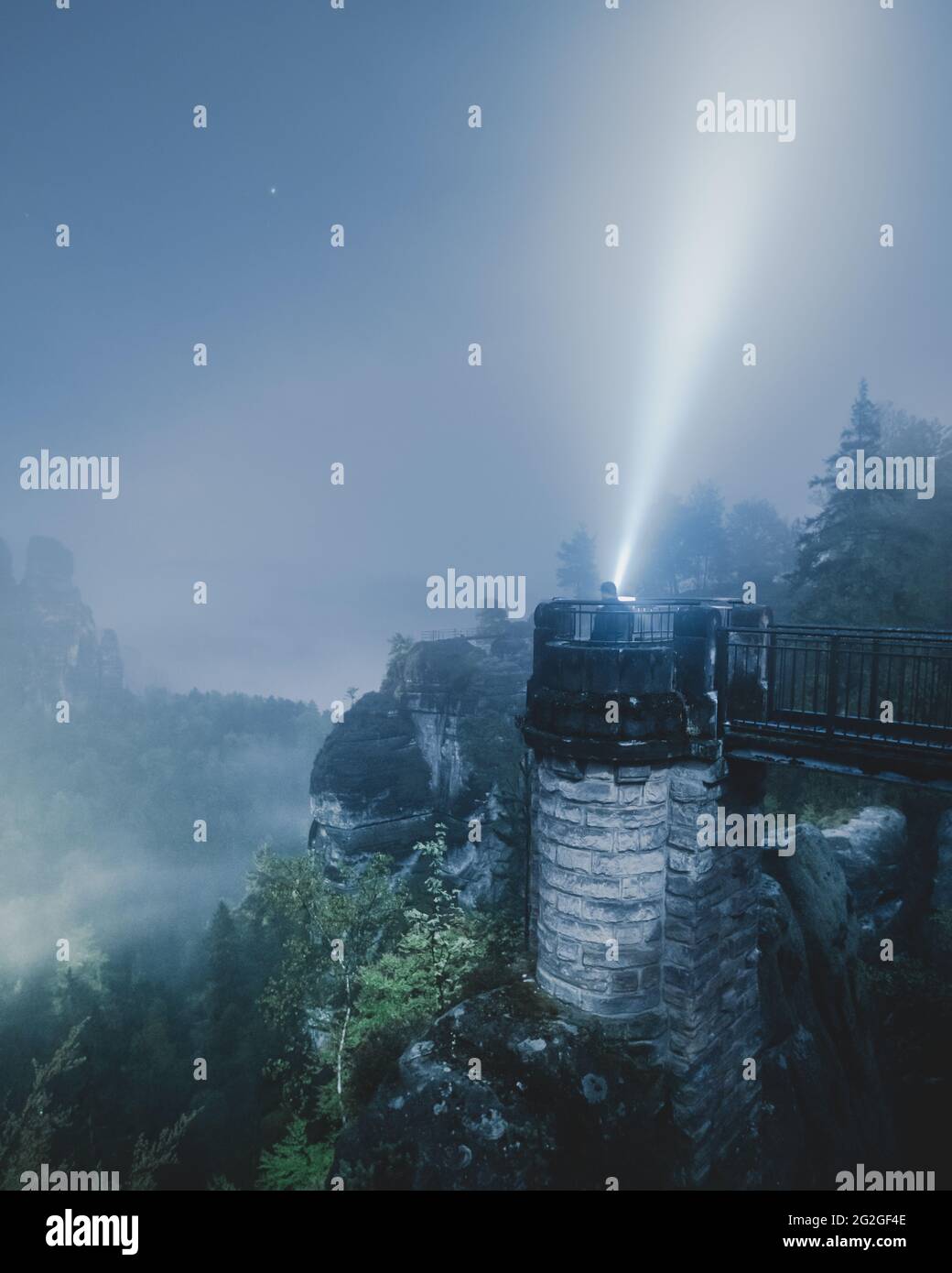 Nocturnal view from the Bastei bridge in the misty Elbe Sandstone Mountains. Stock Photo