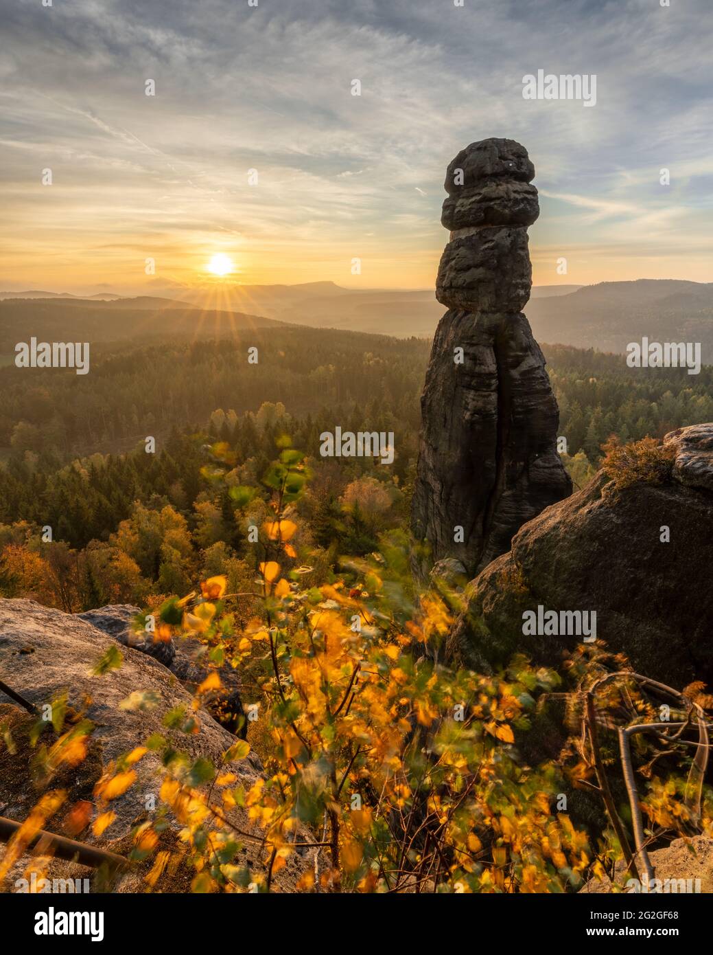 Colorful sunrise behind the Barbarine on the Pfaffenstein in the Elbe Sandstone Mountains. Stock Photo