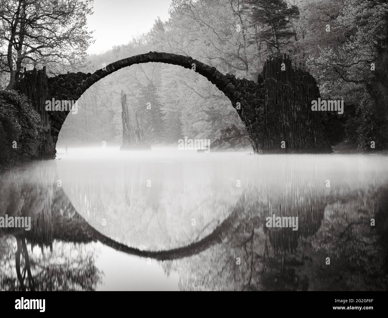 Black and white shot of the historic Rakotzbrücke in the Kromlau Rhododendron Park. Stock Photo