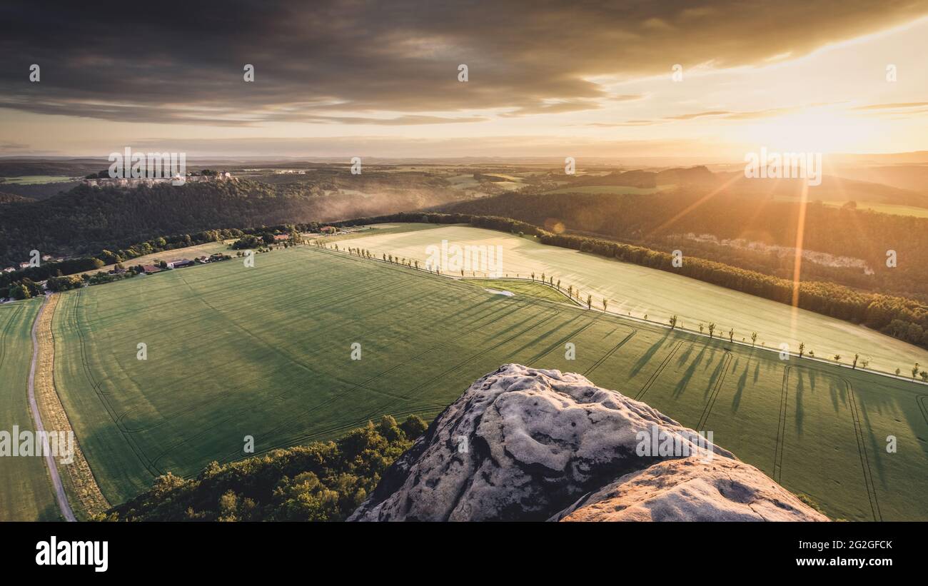 View at sunset from Lilienstein to Königstein Fortress in the Elbe Sandstone Mountains. Stock Photo